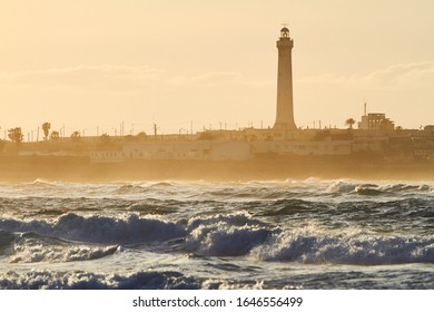 Ocean Coast, Waves At Sunset And A Lighthouse. Casablanca. Morocco