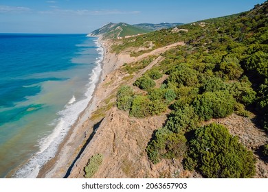 Ocean coastline with waves and highest cliff on coastline. Summer day on sea. Aerial view