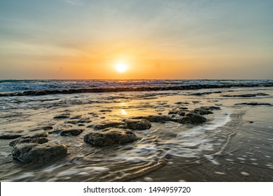 Ocean horizon with rocks sticking out of the foggy water, calm peaceful sunrise on Cabarete beach, Dominican Republic - Powered by Shutterstock