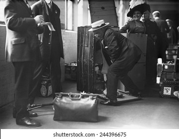 Ocean Liner Passenger Struggling Thorough A Customs Inspection At The Norddeutscher Lloyd Pier In New York City. Ca. 1909