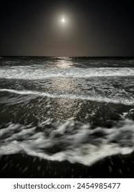 Ocean at night, the moon causing waves