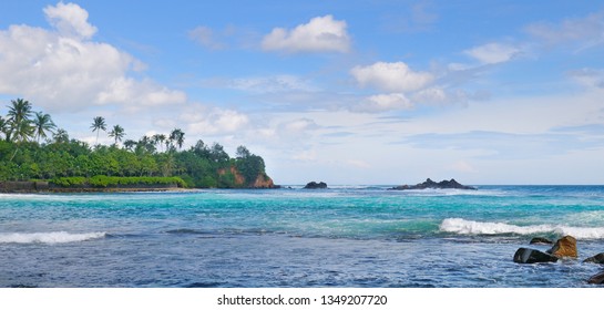 Ocean, picturesque beach and blue sky. Coastline of Sri Lanka. Wide photo.