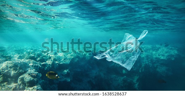 Ocean pollution concept, plastic bag\
floating in the water at the coral reef with copy\
space