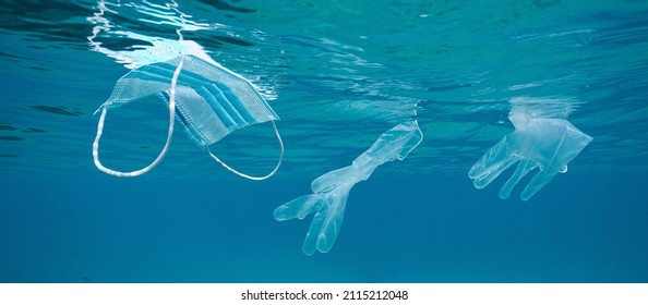 Ocean Pollution Coronavirus Waste, Plastic Face Mask And Gloves Underwater Below Water Surface, COVID-19 Pandemic