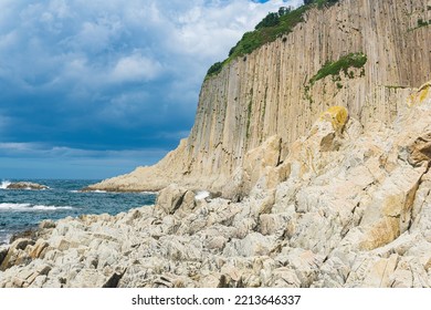 ocean shore with rocks of columnar basalt, Cape Stolbchaty on Kunashir Island - Shutterstock ID 2213646337