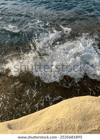 Ocean sunkissed with stone and waves