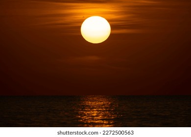 Ocean sunset. Big white sun on dramatic bright sky background, soft evening horizont over sea dark water - Shutterstock ID 2272500563
