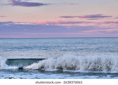 The ocean at sunset with small waves.