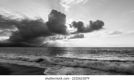 An Ocean Sunset With Sun Rays Emanating From Behind The Clouds Black And White