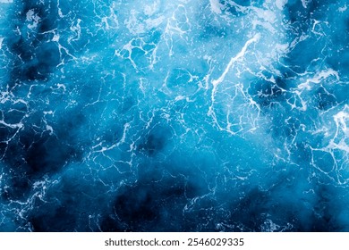 Ocean surface texture. Top view of amazing water with foam. Can be used in covers, packaging, posters, textures, brochures, art, and design projects. Creative nature background image.