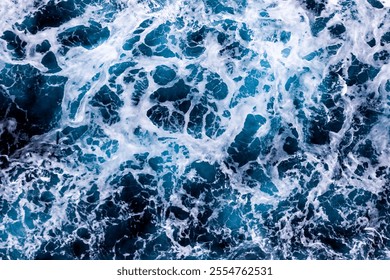 Ocean surface texture. Top view of stunning water with foam. Can be used in covers, packaging, posters, textures, banners, art and design projects. Beautiful nature background image.