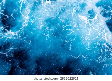 Ocean surface texture. Top view of enchanting water with foam. Can be used in covers, packaging, posters, textures, banners, art and design projects. Stunning nature background image.