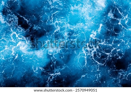 Ocean surface texture. Top view of picturesque water with foam. Can be used in covers, packaging, posters, textures, wallpapers, art, and design projects. Awesome nature background image.