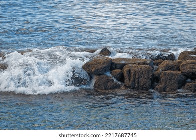 Ocean Surge Over Black Lava Rocks In Hawaii.