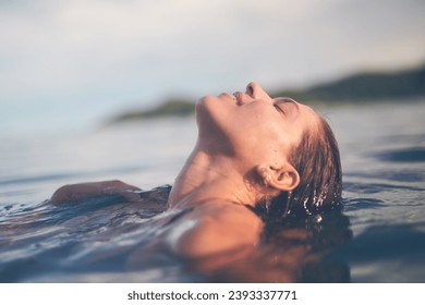 Ocean, swimming and woman with holiday, sea and relax with getaway trip, freedom and outdoor for fun. Person, traveller and girl with vacation, water and summer with weekend break, carefree or travel - Powered by Shutterstock