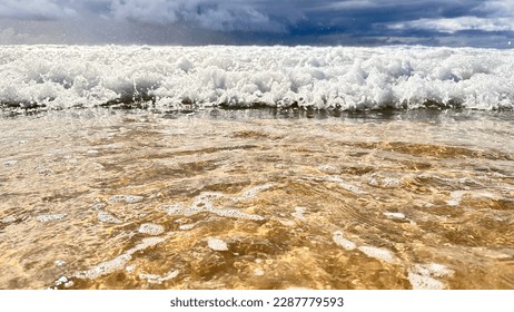 Ocean tide waves rolling in