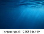 ocean underwater rays of light background, under blue water sunlight
