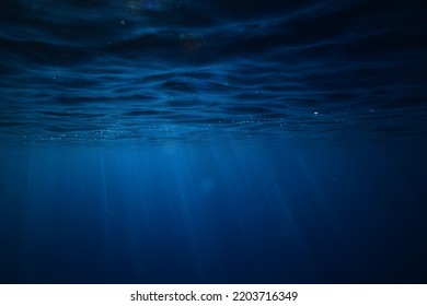 ocean underwater rays of light background, under blue water sunlight - Shutterstock ID 2203716349