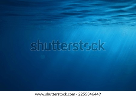 ocean underwater rays of light background, under blue water sunlight