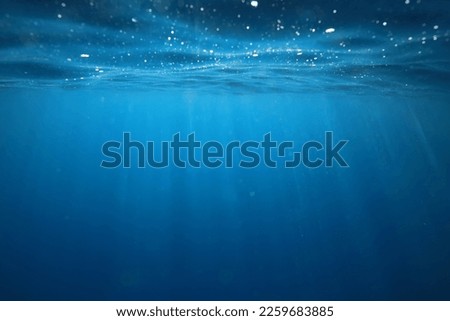 ocean underwater rays of light background, under blue water sunlight