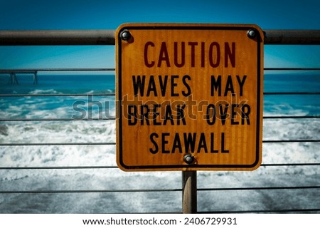 ocean view braking waves with caution sign