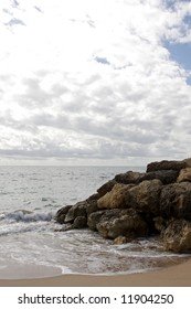A ocean view with clouds and rocks
