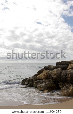 A ocean view with clouds and rocks