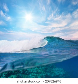 ocean view cloudy sky and breaking surfing wave splitted to two parts by waterline