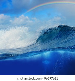 Ocean View Cloudy Sky With Colourful Rainbow And Breaking Surfing Wave Splitted To Two Parts By Waterline