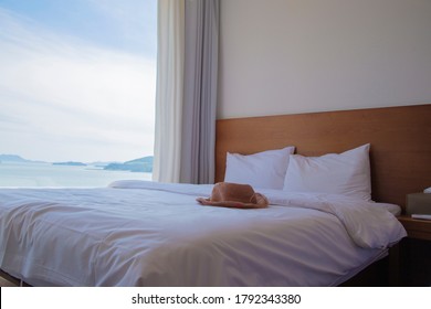 Ocean View Hotel Room With A Hat On The Bed