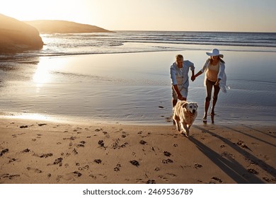 Ocean, water and couple with dog at sunset for outdoor vacation, travel and adventure together. Weekend, woman and man holding hands with furry pet at beach for love, support and holiday in Cancun - Powered by Shutterstock