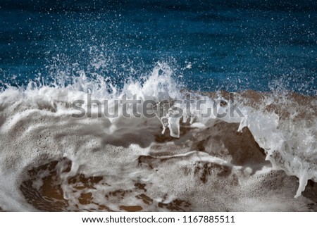 waves and splashes of sea surf and stones on the seashore in Egypt Dahab South Sinai