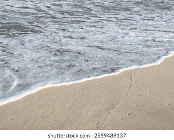 Ocean waves are crashing against the beach due to the high tide.
Water soft waves on sand, Ocean water wake. Seashore water foam over clean sandy beach, Soft Wave Of Sea On Sandy Beach. - Powered by Shutterstock