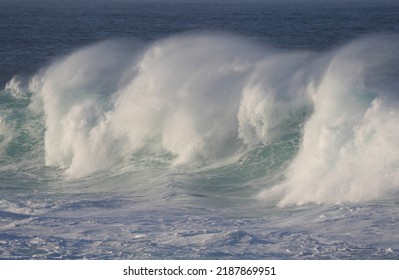 Ocean waves crashing down causing white foam on the water