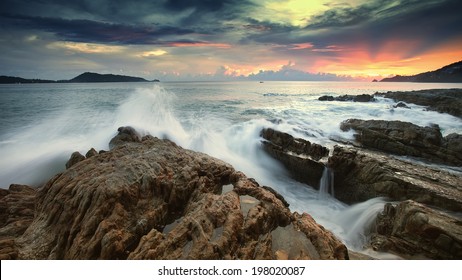 Ocean waves crashing onto the rocks in the sunset - Powered by Shutterstock