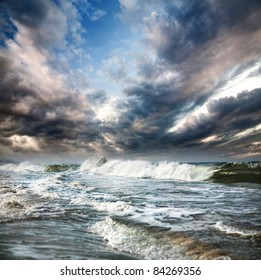 Ocean with waves and dramatic blue sky with clouds