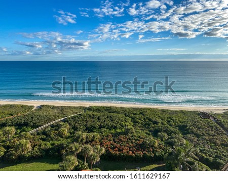 Ocean waves lapping on the beach  on a beautiful sunny day along the shoreline on North Hutchinson Island Florida.