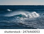Ocean waves in motion, showing the energy of the sea with splashes and mist.