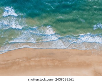 Ocean waves on the beach as a background. Aerial top down view of beach and sea with blue water waves. Beautiful natural summer vacation holidays background in Vietnam. Vietnam beach - Powered by Shutterstock