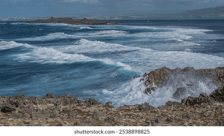 The ocean waves are raging in the strait between the rocky islands. Foam, splashes on volcanic rocks. Mauritius. Île au Phare  - Powered by Shutterstock