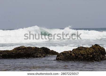 ocean waves that head towards the beach. These waves will hit the coral rocks on the edge of the beach 