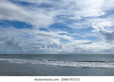 Ocean waves under a cloudy sky