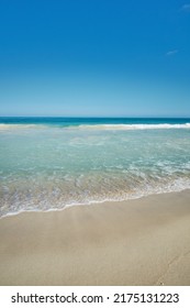 Ocean waves washing onto an empty beach shore in a tropical resort with clear blue sky and copyspace. Calm and peaceful landscape to enjoy in summer for a relaxing holiday abroad or vacation overseas - Shutterstock ID 2175131223