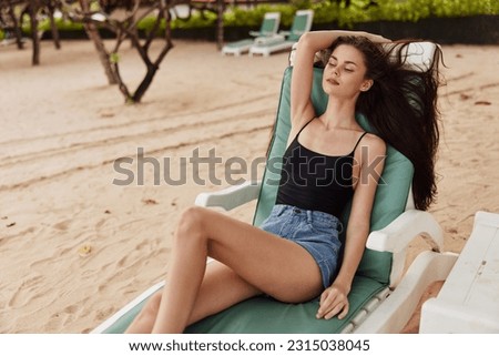 ocean woman sunbed sea beach lying lifestyle smiling sand sitting resort