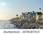 Oceanside beach houses in California with stairs on the natural rock seawall