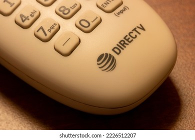 Oceanside, CA, USA - May 15, 2022: DIRECTV Logo Is Seen On A Remote Control On A Wooden Table In A Hotel Room. DirecTV Is An American Multichannel Video Programming Distributor.