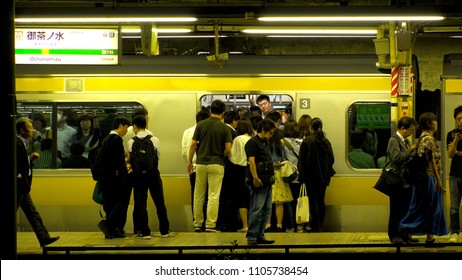 OCHANOMIZU, TOKYO,  JAPAN - CIRCA JUNE 2018 : BUSINESS MAN And COMMUTER At OCHANOMIZU Train Station Platform At Night In Busy Rush Hour.