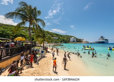 Ocho Rios, Jamaica - April 22, 2019: People relax on the Fisherman's Beach near Ocho Rios Cruise Ship pier. Today the city is one of Jamaica's most top tourist destinations.