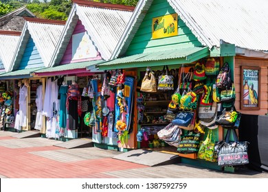 Ocho Rios, Jamaica - April 23 2019: Jamaican/ Rasta/ Rastafarian color clothing, bags and other items for sale at colorful tropical Craft Market stores in Ochi, Jamaica