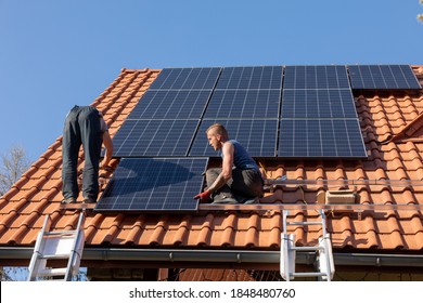 Ochojno, Poland - April 8, 2020: Workers installing solar electric panels on a house roof in  Ochojno. Poland - Shutterstock ID 1848480760
